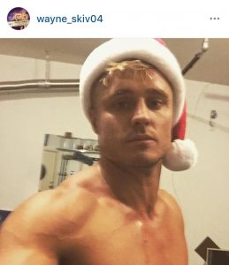 Super Dad wayne skivington poses in santa hat