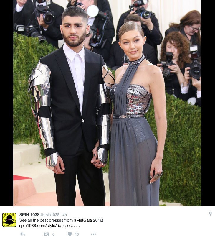 Zayn Malik poses in a suit with metal armour on his arms next to Gigi Hadid at the 2016 Met Gala 
