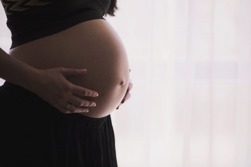A pregnant woman's stomach - the woman is having a child thanks to Sims IVF