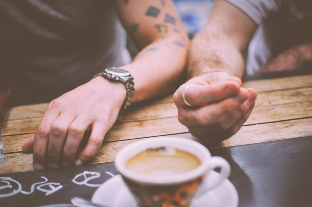 Two people's hands with a coffee on a table - clearly they've checked out GCN's romantic date ideas Dublin guide