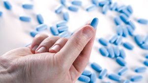 PrEP pills held between thumb and forefinger, which represents the PrEP service Ireland could provide as one of the LGBT issues that could benefit from Apple's €13b tax bill