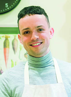 James Kavanagh in an apron, the food reviewer who reviews pickle