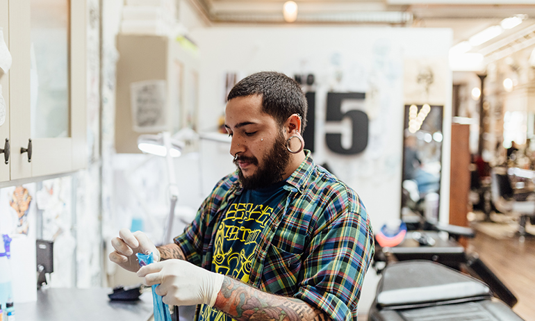 German Ferrerioa preparing a tattoo needle is one of the LGBT people in Real Irish Jobs