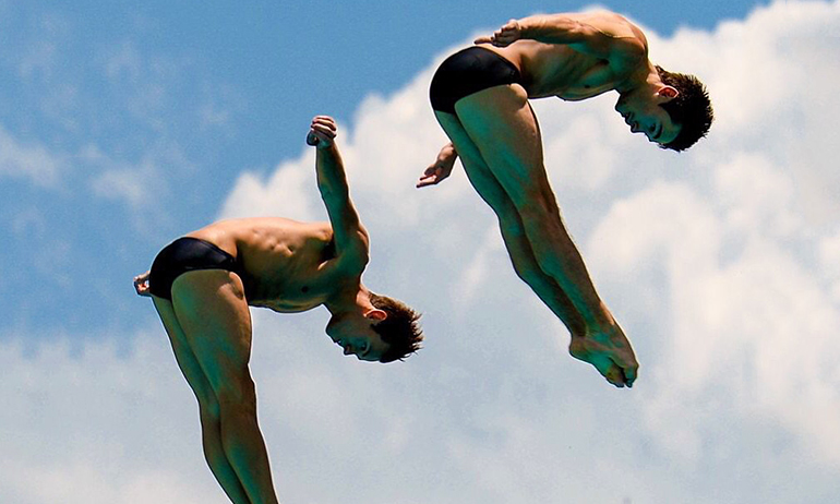 Olympic divers mid dive, with Olympic divers being one of the halloween costumes for gay men