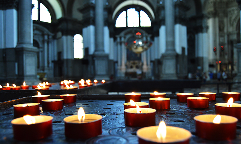 Candles in a church representing religion which is one of the things to consider before coming out to your irish parents