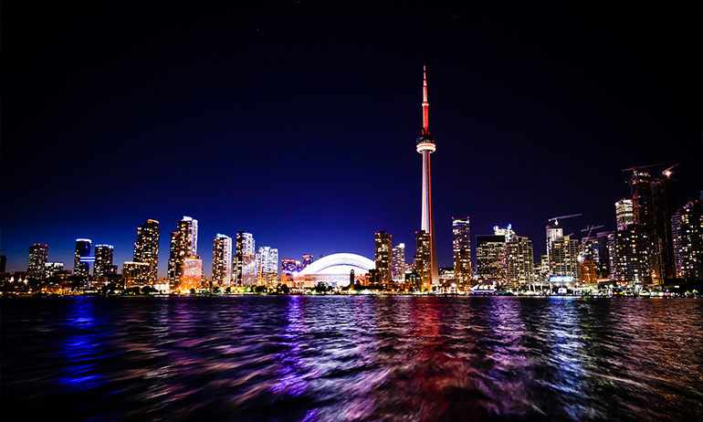 The night skyline of Toronto, Canada which is one of the lgbt friendly places that the irish diaspora can travel to instead of the US