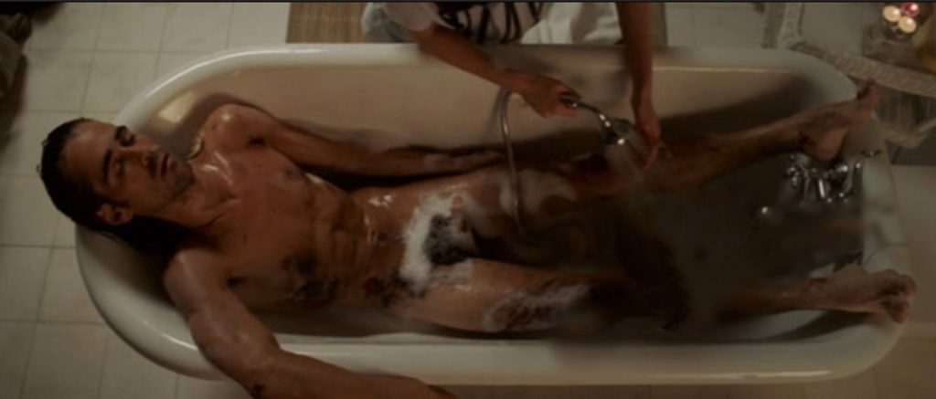 Colin Farrell lying naked in a bath with suds not hiding his full-frontal nudity