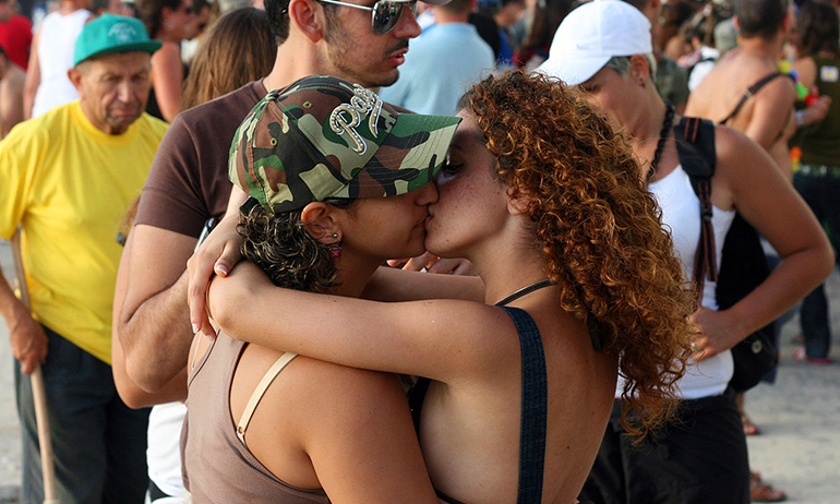 Two women kissing, representing LGBT friends or family of your parents, one of the things to consider before coming out to your irish parents
