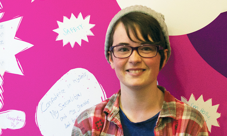 Ray standing in front of the belong to sign, who is one of the young Irish LGBT interviewed for GCN's 2016 Youth Issue