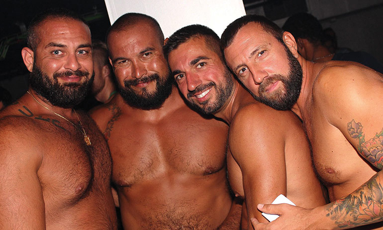 4 gay bears hugging at Sitges Bear Week, one of the top ten queer travel events of 2017