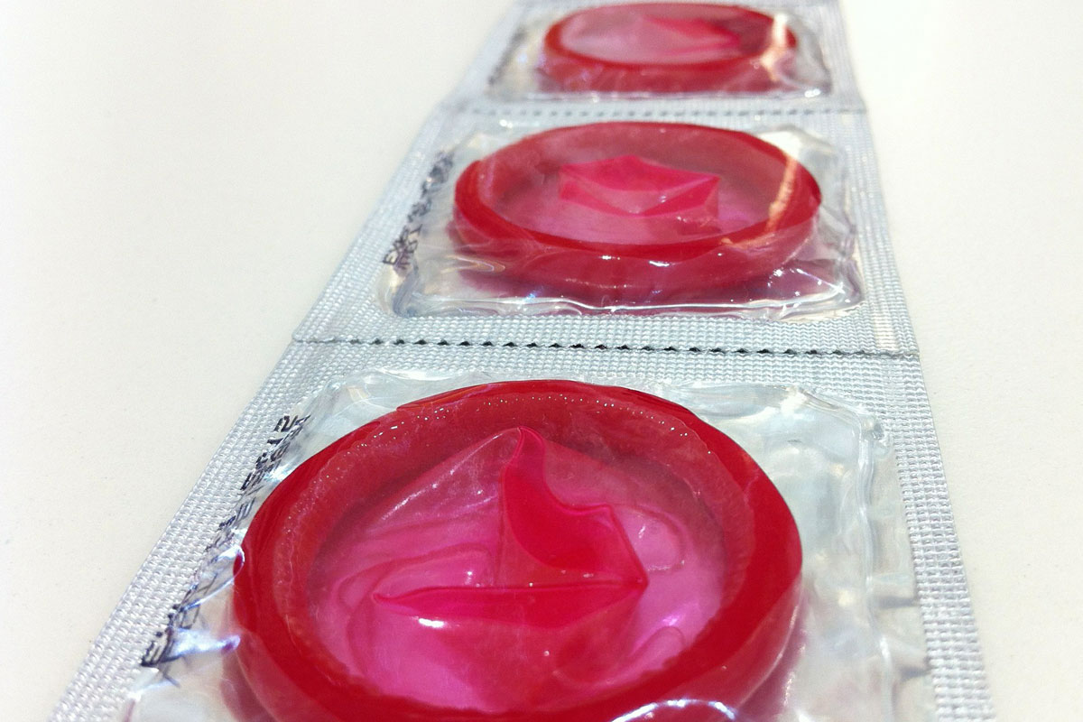 A strip of red condoms which is one of the things suggested to prevent STIs in the Truvada Diaries