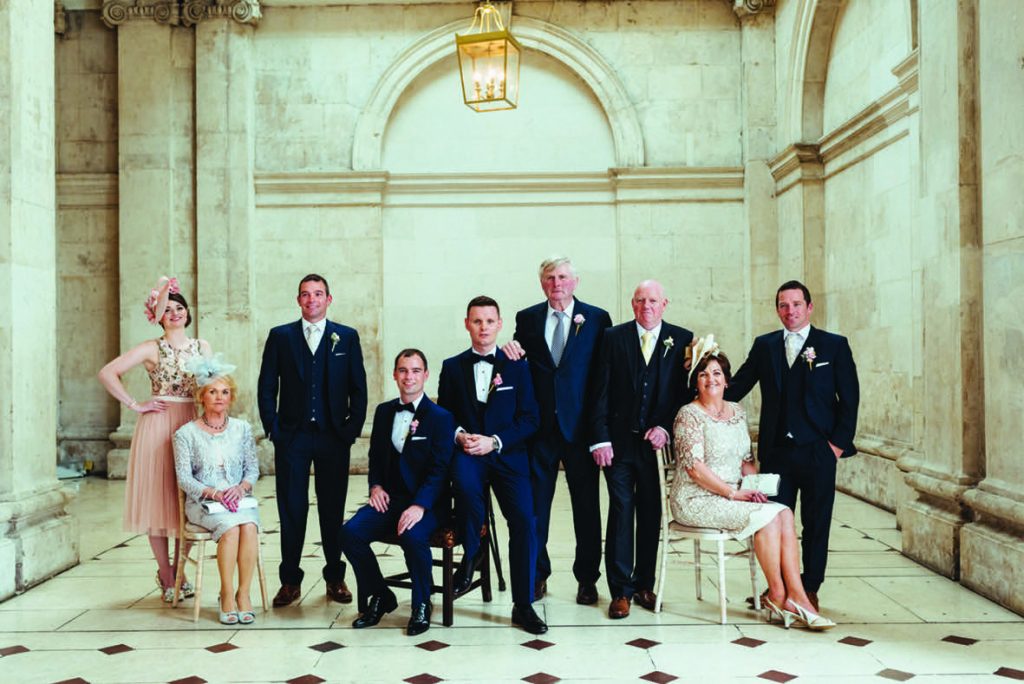 Andrew and thomas and their families in suits and dresses for their Real Weddings article