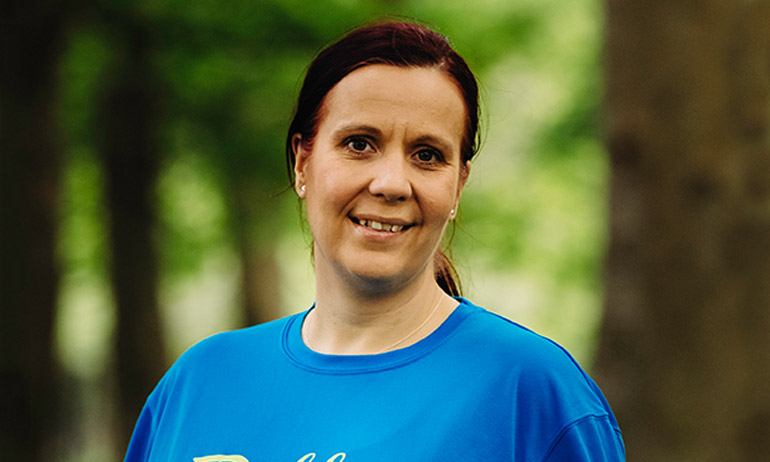 One of the Dublin Front Runners smiling and wearing a blue Dublin Pride Run T shirt