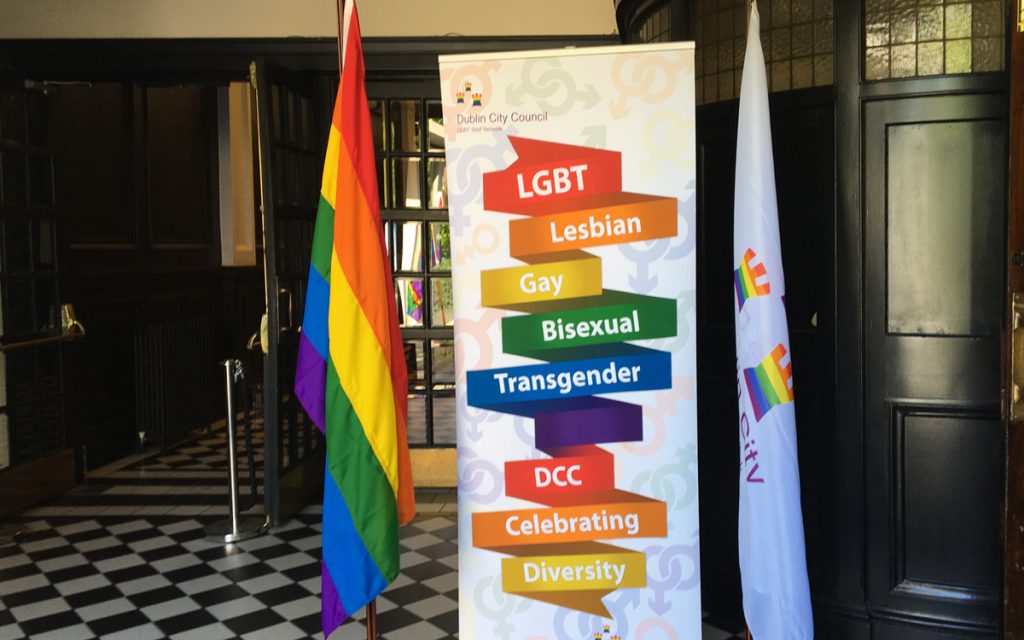 a rainbow flag and a poster saying LGBT lesbian gay bisexual transgender DCC Celebrating Diversity on coloured ribbon from the launch of the DCC LGBT Inclusion Strategy