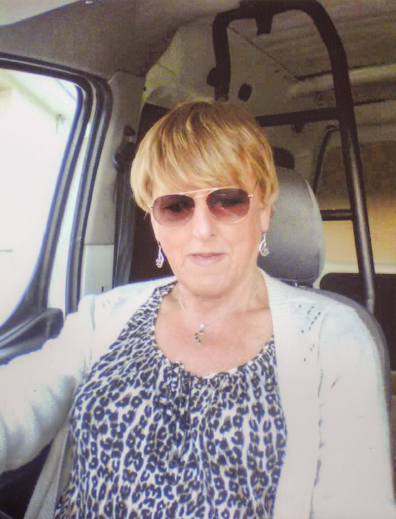Christine Beynon from the art exhibition in Becoming Christine sitting in a car with sunglasses on