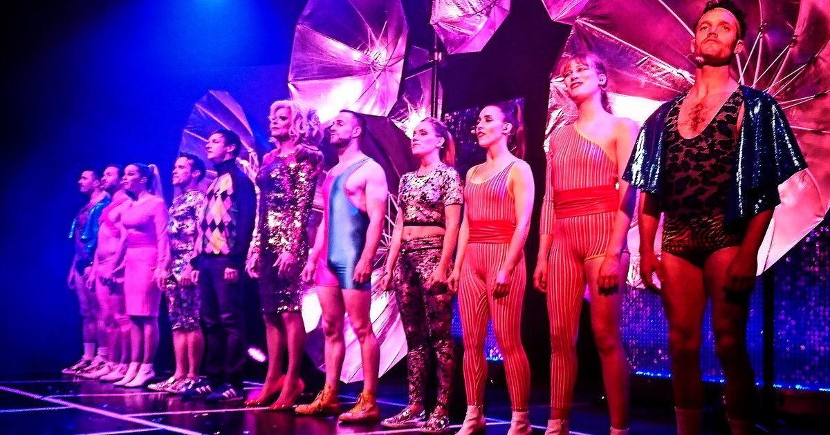 The entire cast on RIOT on stage facing the public for the final performance