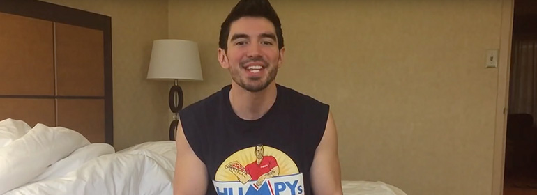 Singer Steve Grand sitting on a bed talking about what kills his boner
