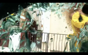 Trans Beyoncé Impersonator smashing a car window with a baseball bat with smashed glass shattering