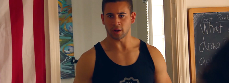 gay stereotypes video featuring a muscle bottom in a black tank top