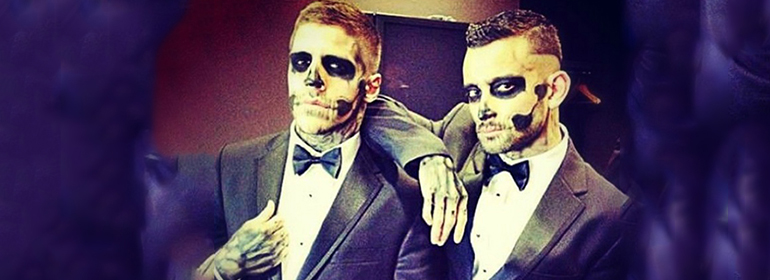 Two skeletons dressed up in suits which is one of the halloween costumes for gay men