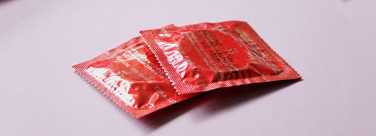 2 Condoms in red packaging, which are an effective way of preventing HIV, syphilis and gonorrhoea in MSM