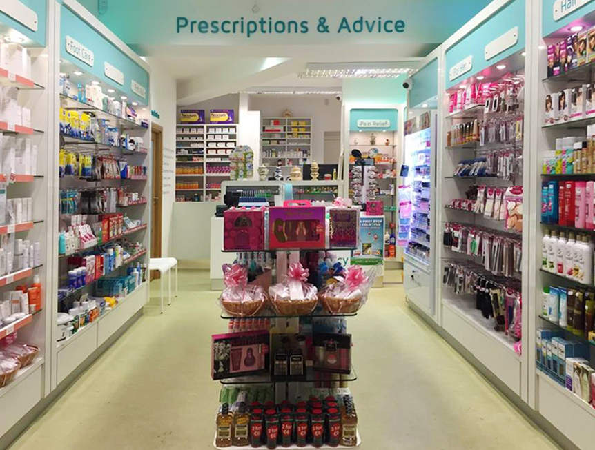 A display unit in Capel St. Pharmacy with beauty products on it and the service counter in the background