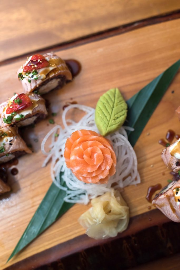 Close up of salmon on a sushi board from Yamamori Sushi, who's manager Graham Ryan we interviewed in this month's Amuse Bouche