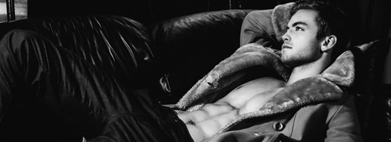Dustin McNeer in a hoody lying down, who happens to be one of the stories in today's Cuppán Gay