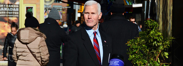 Mike Hot-Pence in a suit holding a donation bucket who is one of today's Cuppán Gay posts