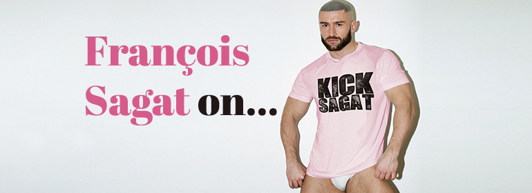François Sagat in a pink t-shirt that says kick sagat