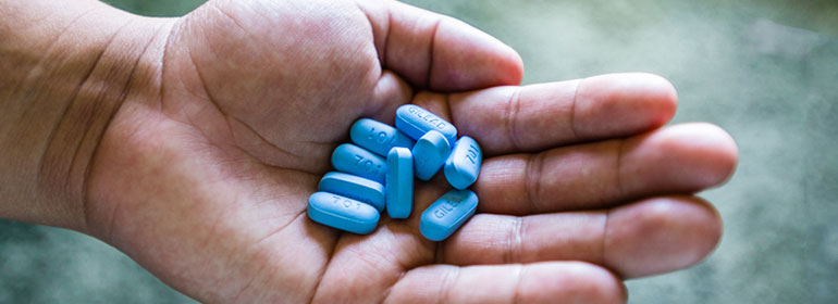 A person holding truvada PrEP pills for the irish PrEP study with UCD and The Mater who are looking for gay men and trans women to participate.