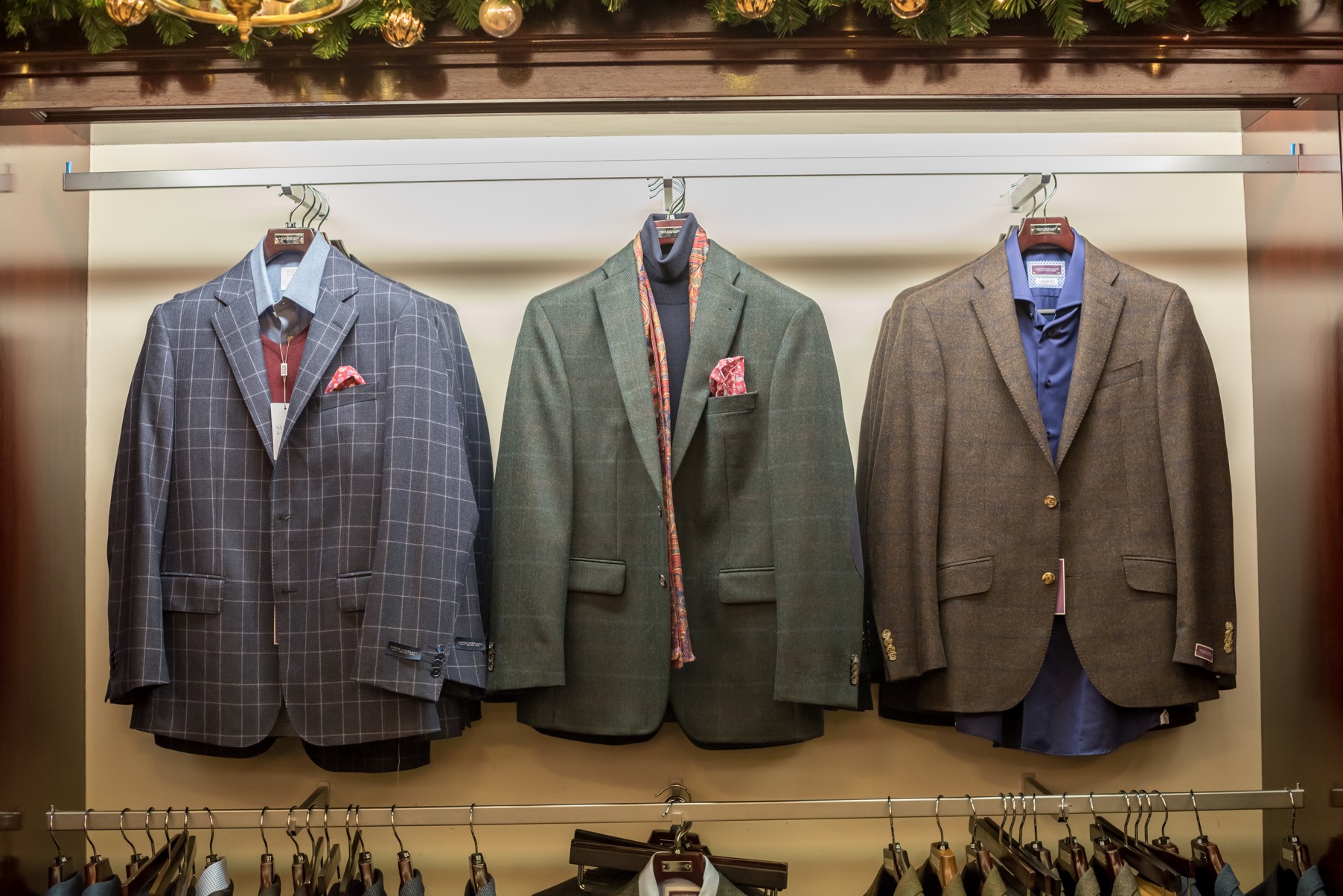 A range of blue, green and brown suits at a Louis Copeland store