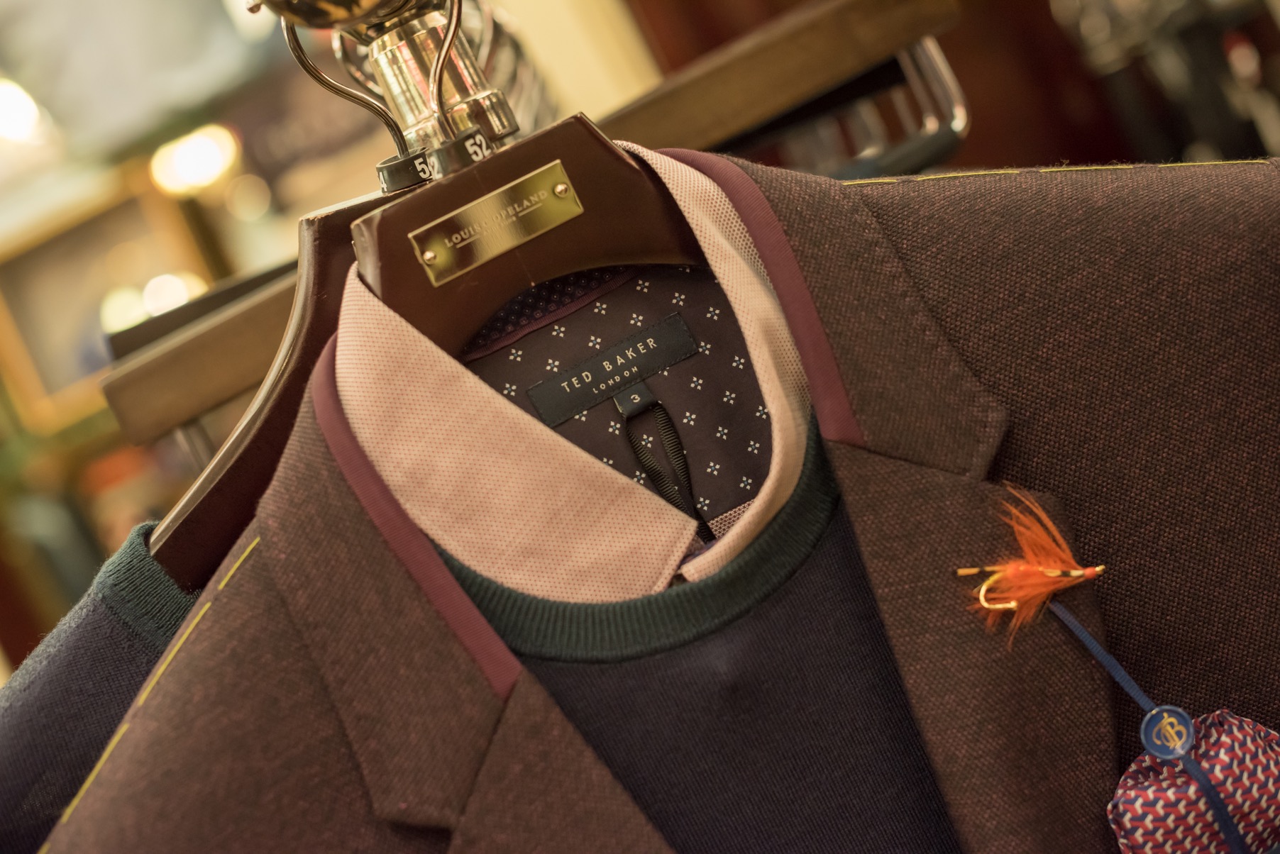A shirt, jumper and jacket combo at a Louis Copeland store