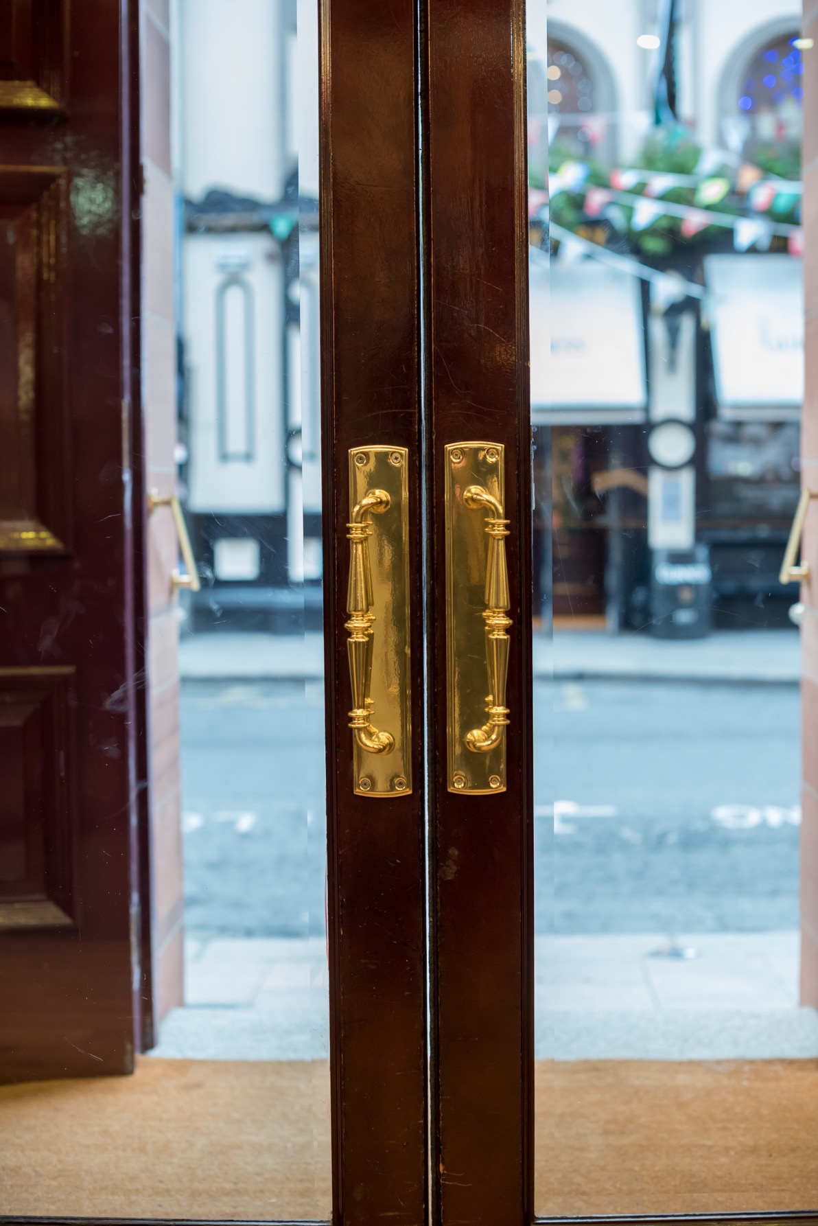 The doors with gold handles and glass at a Louis Copeland store