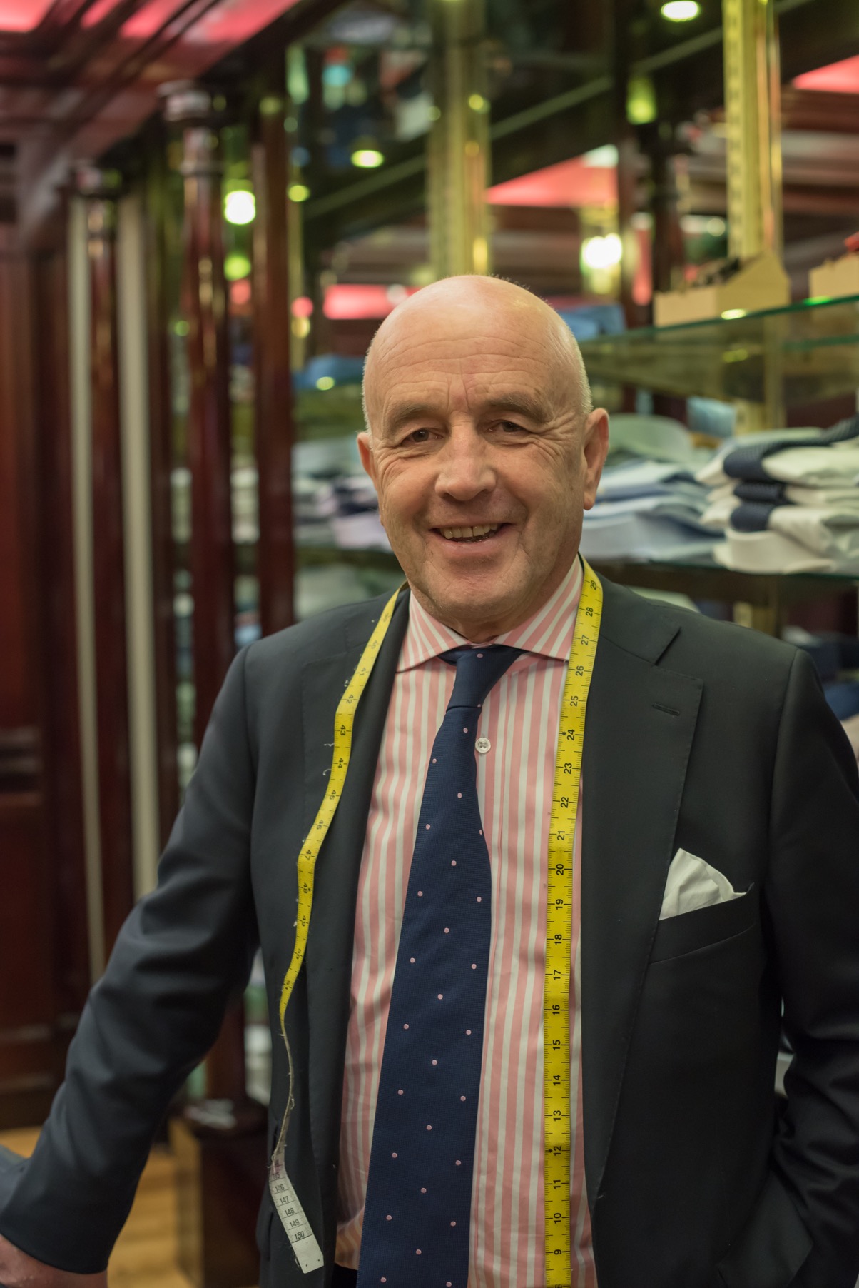 Louis Copeland standing with a measuring tape around his neck at a Louis Copeland store