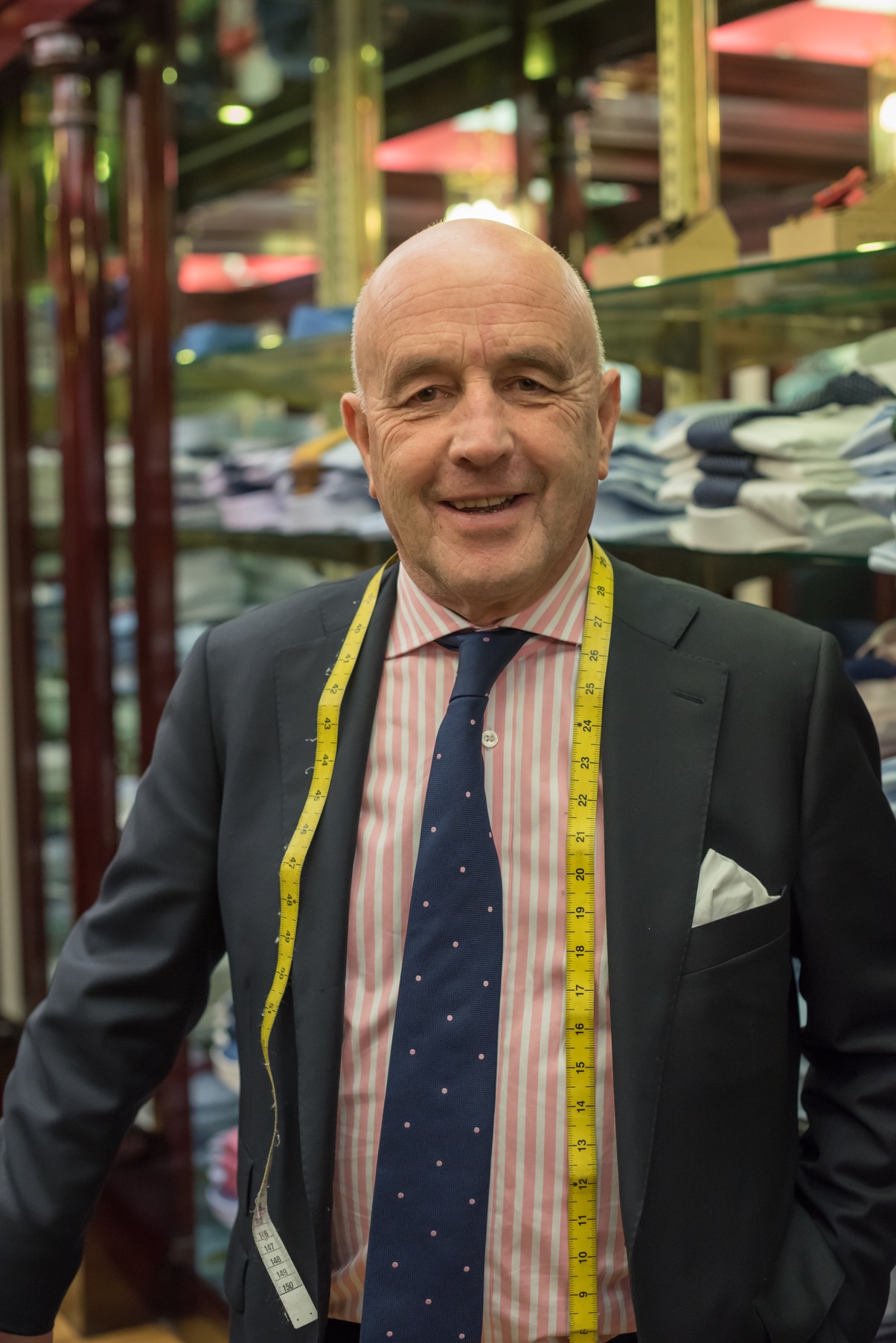 Louis Copeland standing with a measuring tape around his neck at a Louis Copeland store