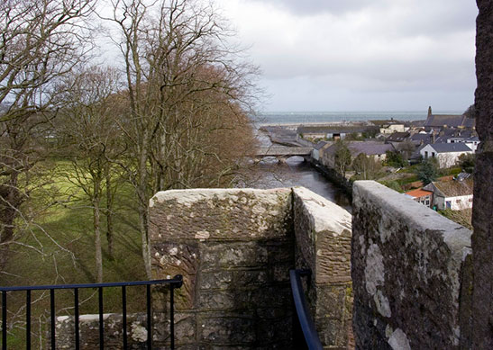 The view from atop a castle looking over a river at a bridge and trees at one of the Irish Landmark Trust venues - the same Irish Landmark Trust who has a Valentine's Giveaway