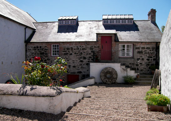A gorgeous sunny stone cottage with a red door at one of the Irish Landmark Trust venues - the same Irish Landmark Trust who has a Valentine's Giveaway