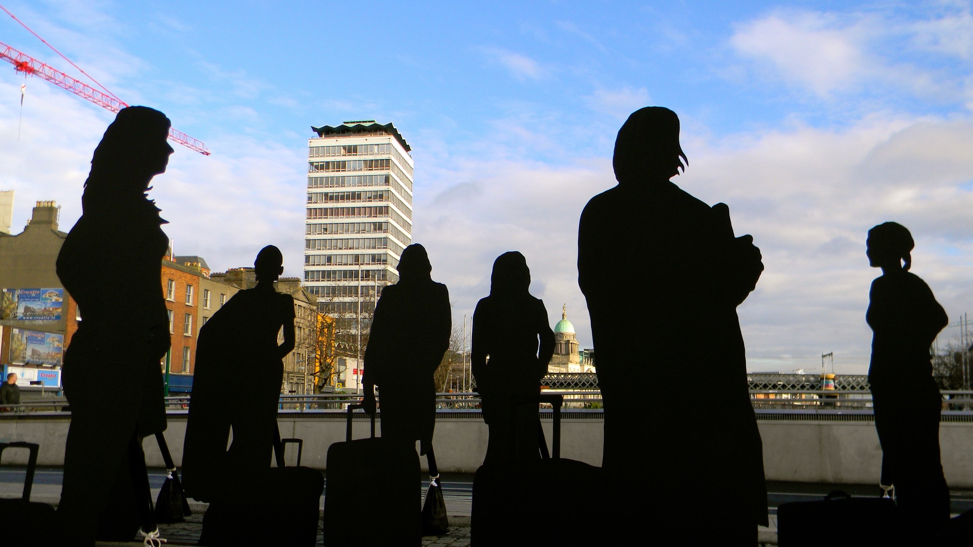 The silhouettes of women in Dublin with a suitcase as part of Will St Leger's Out of the shadows art project