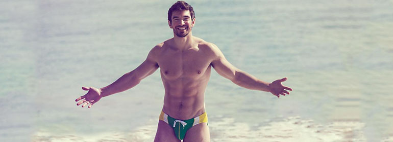 Steve Grand, who is featured in today's Cuppán Gay, standing in swimwear in the sea
