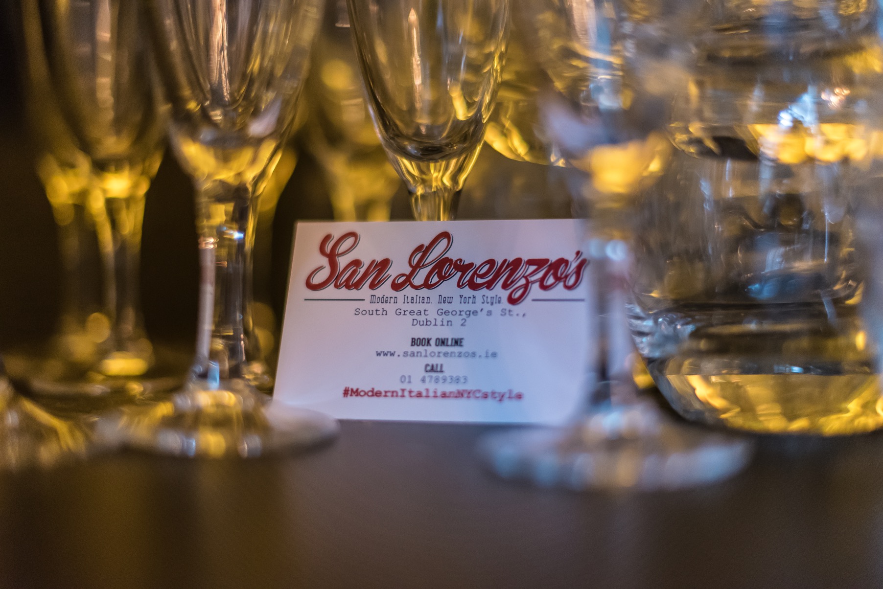 A San Lorenzo's business card and wine glasses