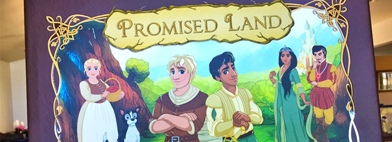 One of the stories from today's Cuppán Gay, the cover of the fairytale book Promised Land with two male lovers in the centre and supporting characters on either side in medieval looking clothing