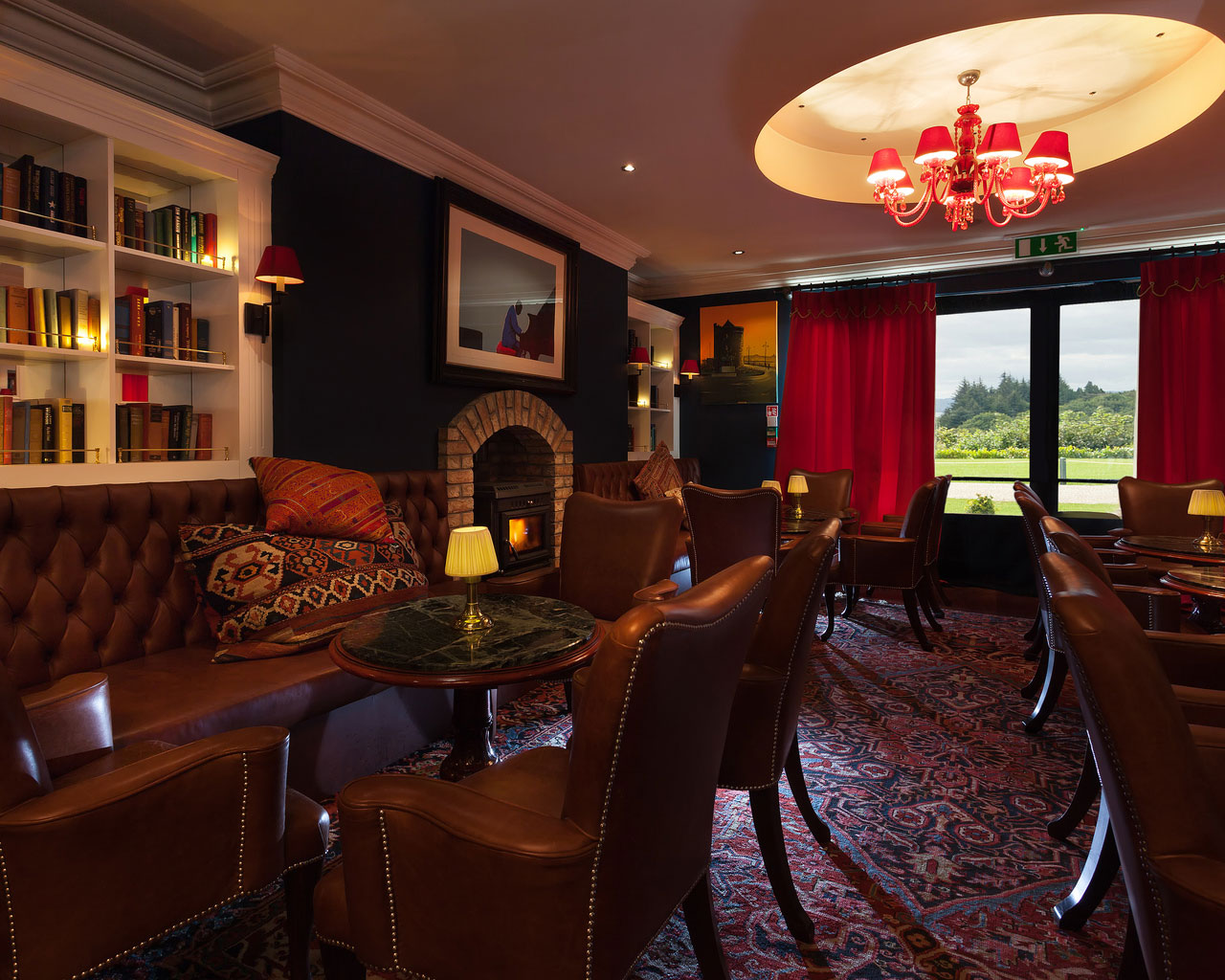 An interior shot of the lodge at ashford castle where if you book a wedding, you could win a luxury cruise to the value of e10000 with chairs and couches in a rich looking room