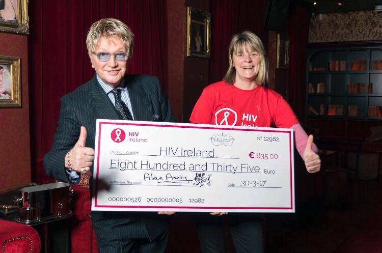 Mr Pussy presenting HIV Ireland with a giant cheque for €835
