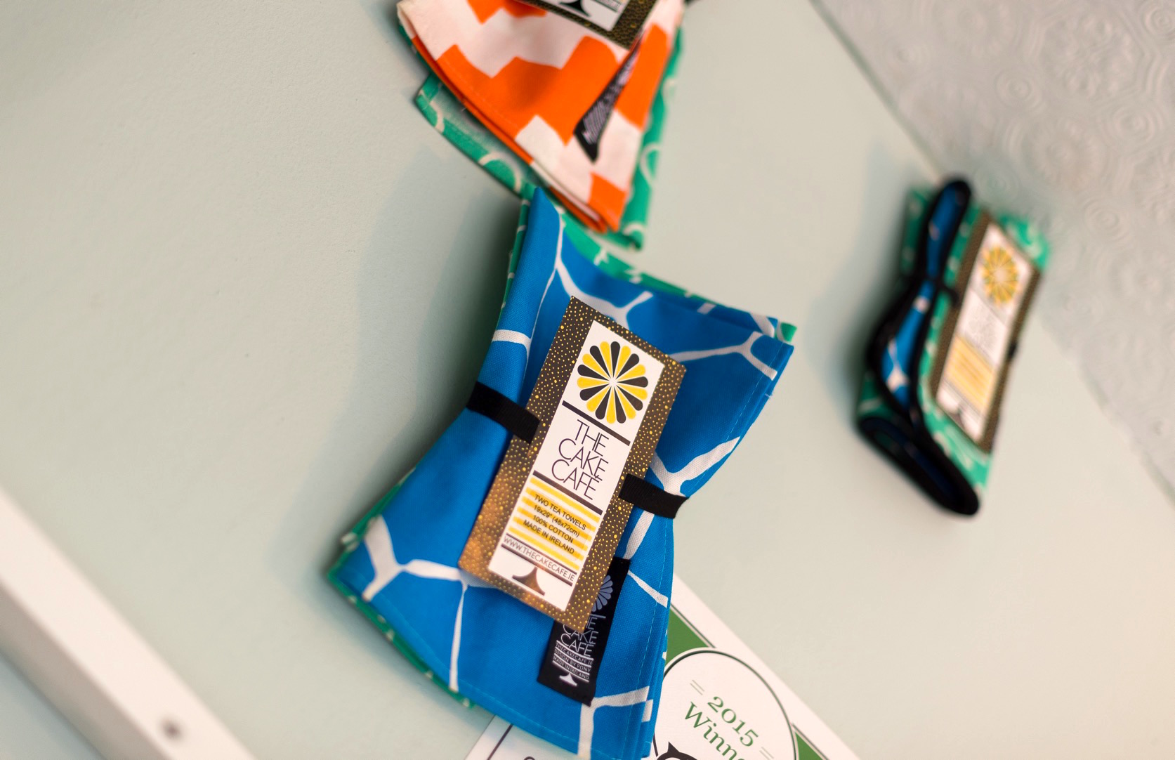 Brightly coloured tea towels at the cake cafe and slice which are both owned by Ray O'Neill