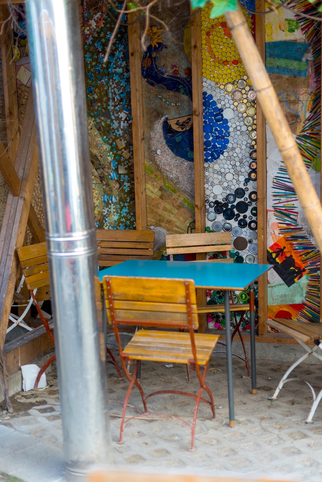 Wooden chairs and a painted wall in the outdoor seating area at the cake cafe and slice which are both owned by Ray O'Neill