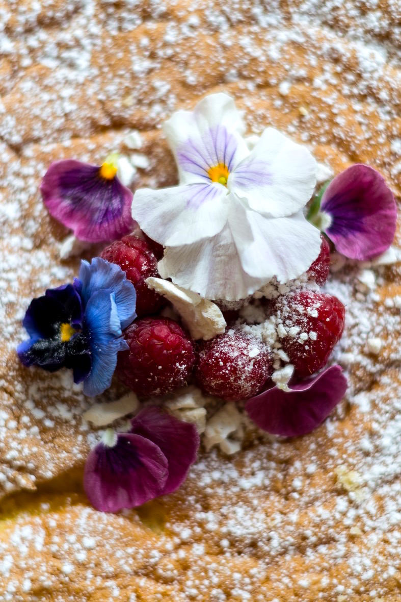 Gorgeous flowers and fruit atop an iced baked good at the cake cafe and slice which are both owned by Ray O'Neill