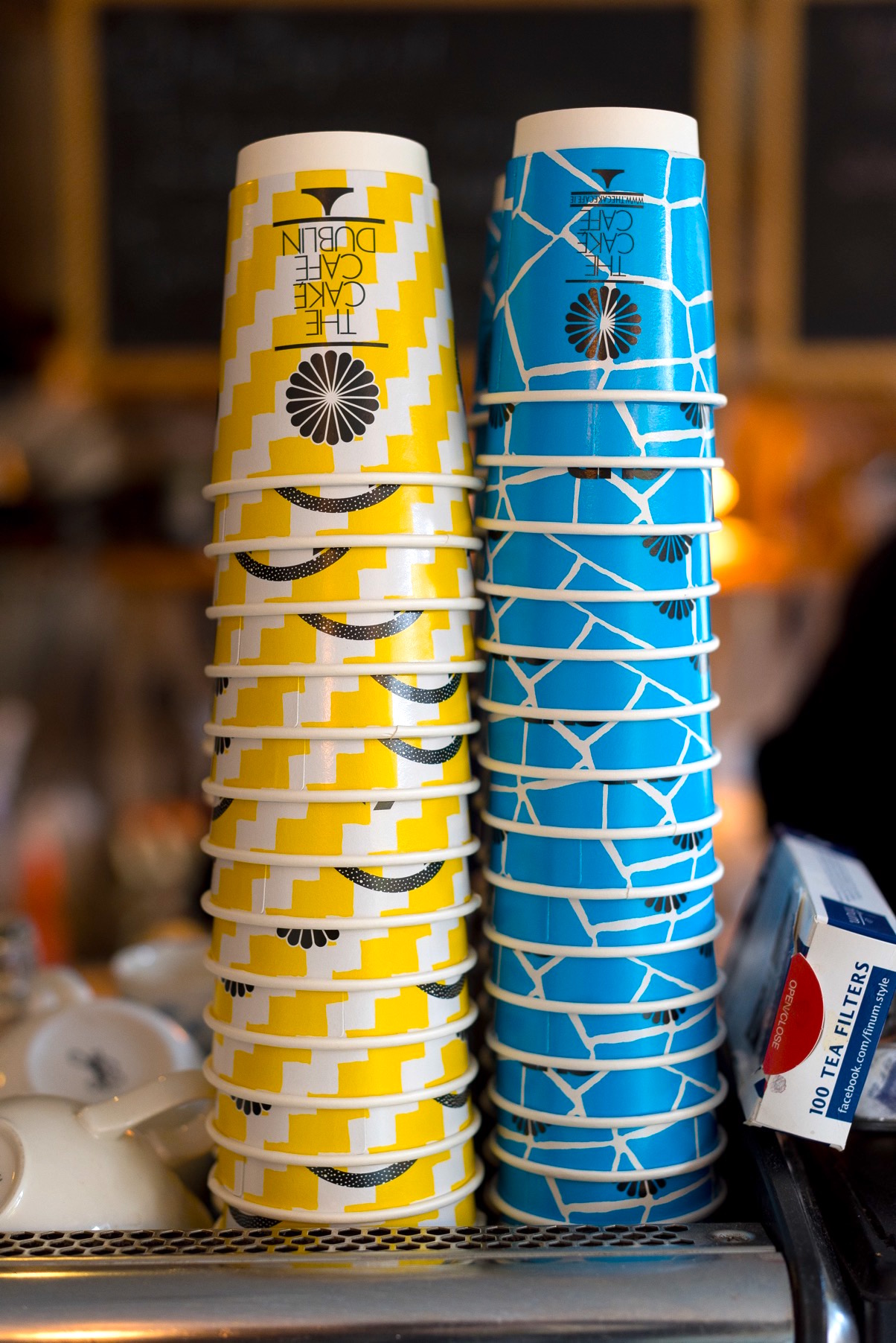 Yellow and blue coffee takeaway cups at the cake cafe and slice which are both owned by Ray O'Neill
