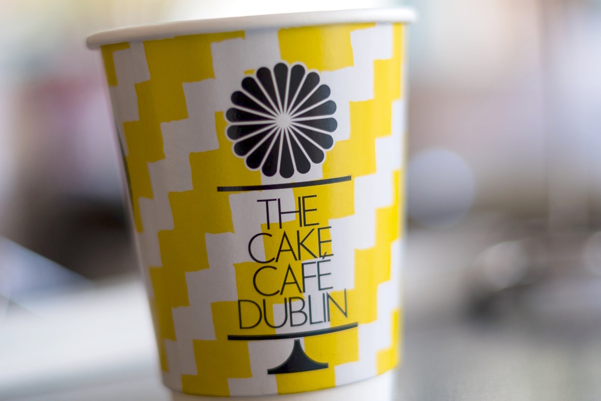 A yellow Cake Cafe Dublin coffee cup at the cake cafe and slice which are both owned by Ray O'Neill