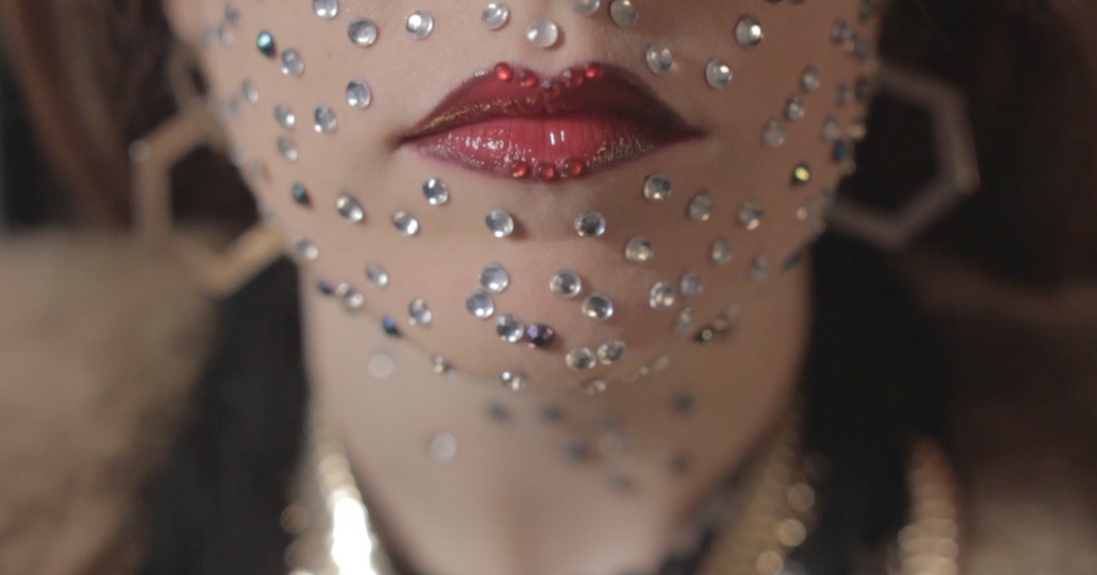 Close up of singer Sarah Byrne's lips, rhinestones on her face